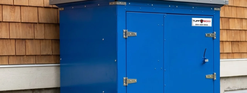 Wild skunk at Canadian residential home with cedar siding investigating TuffBoxx blue galvanized steel wildlife-resistant storage container demonstrating urban wildlife pressure and secure storage solution