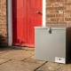 ParcelBoxx lockable steel delivery box installed at residential front door with red entrance to prevent parcel theft and secure packages